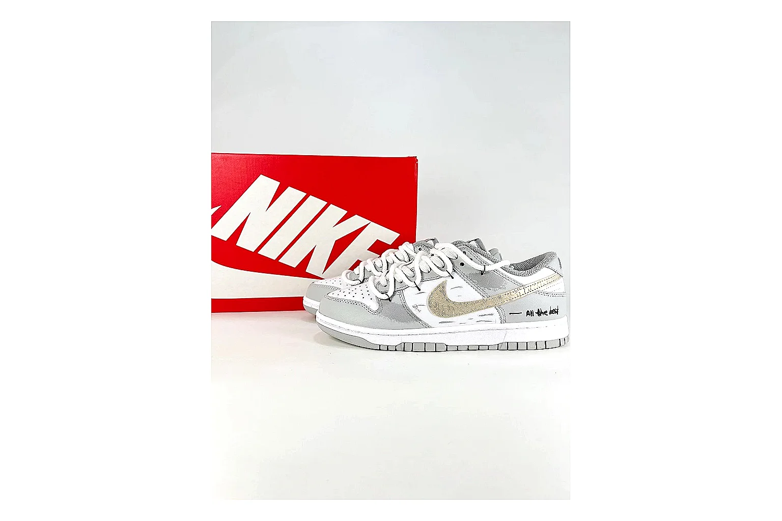 Nike Silver Runner Silver Gold QC reference photo showing silver synthetic-mesh upper, gold accent details, modern runner shape, and cushioned sole