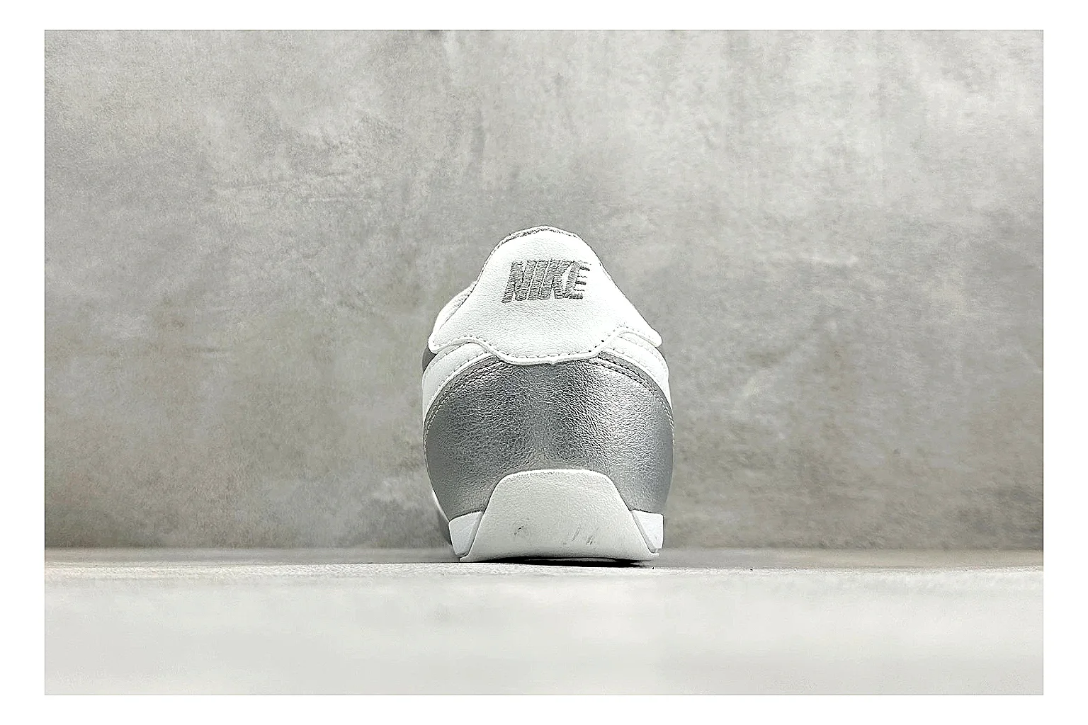 Nike Sprint Sister Silver QC reference photo showing silver retro-runner upper, slim low-top shape, layered side panels, and a light everyday sole