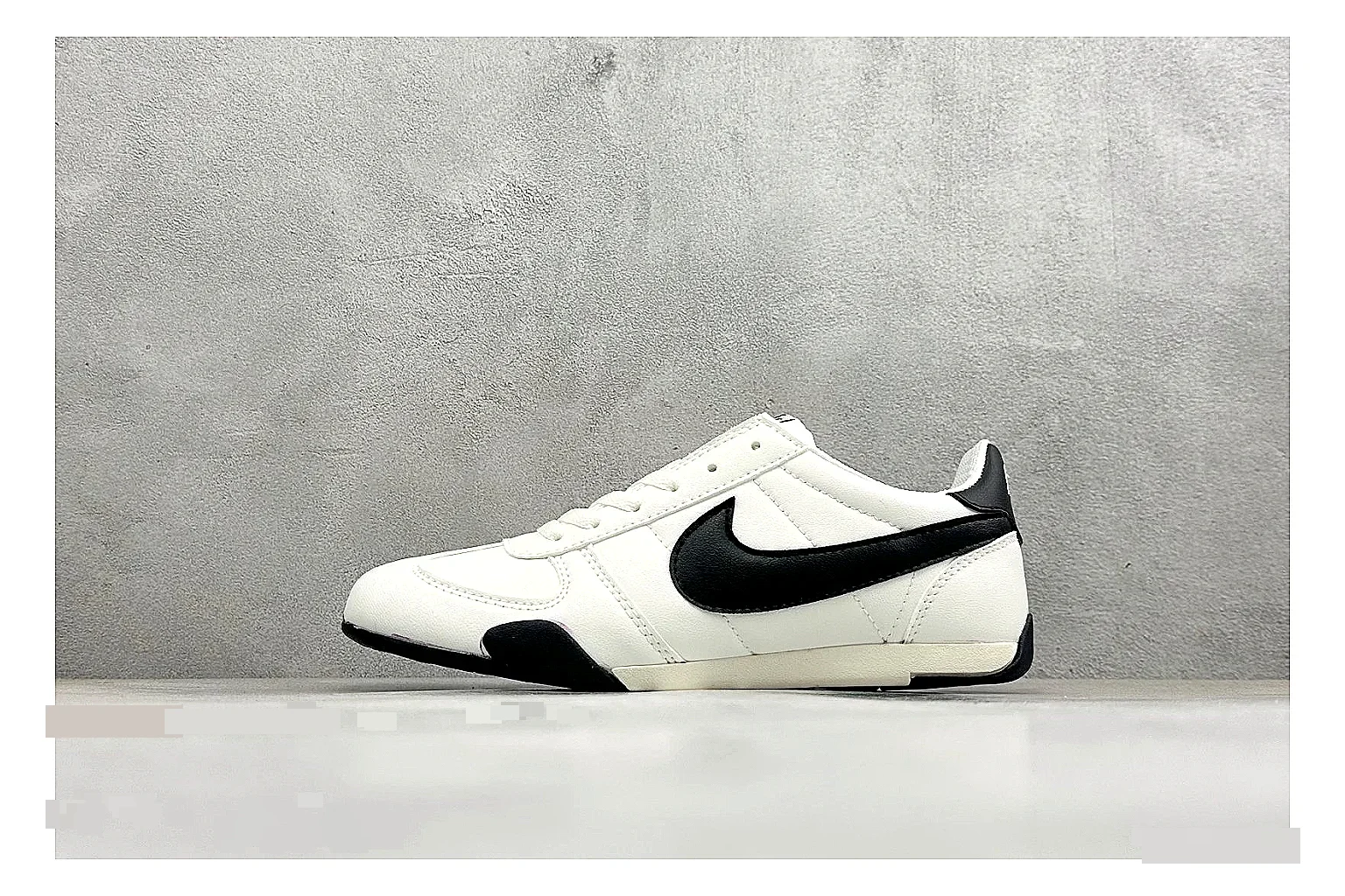 Nike Sprint Sister White Black QC reference photo showing white retro-runner upper, black Swoosh contrast, slim low-top profile, and light casual sole