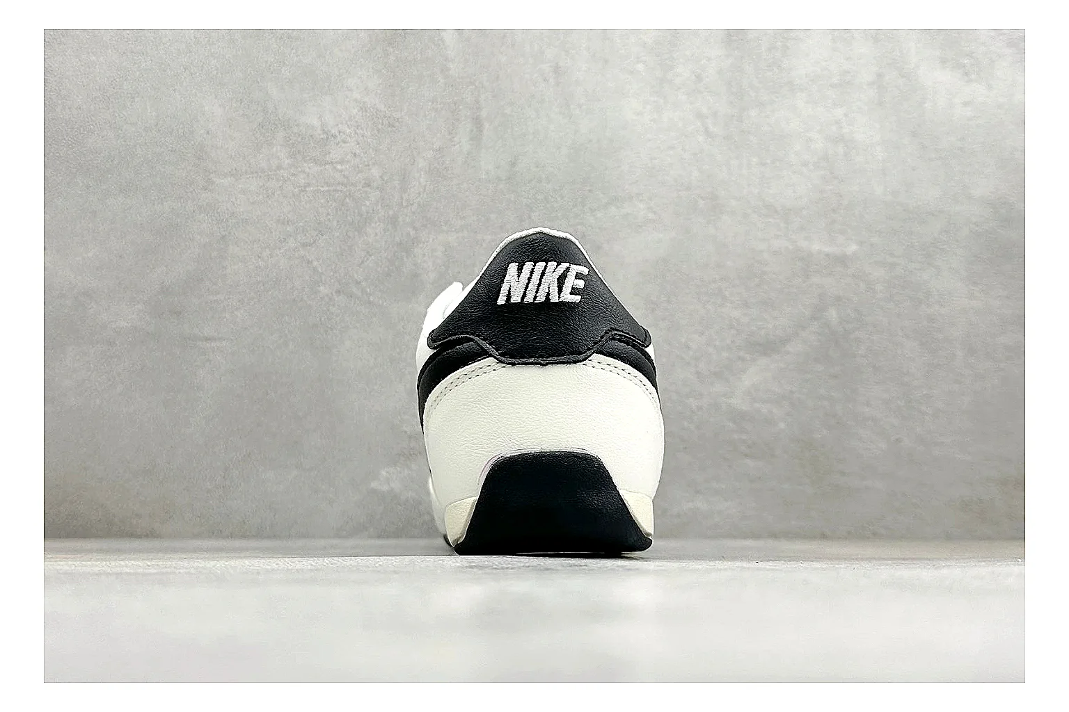 Nike Sprint Sister White Black QC reference photo showing white retro-runner upper, black Swoosh contrast, slim low-top profile, and light casual sole
