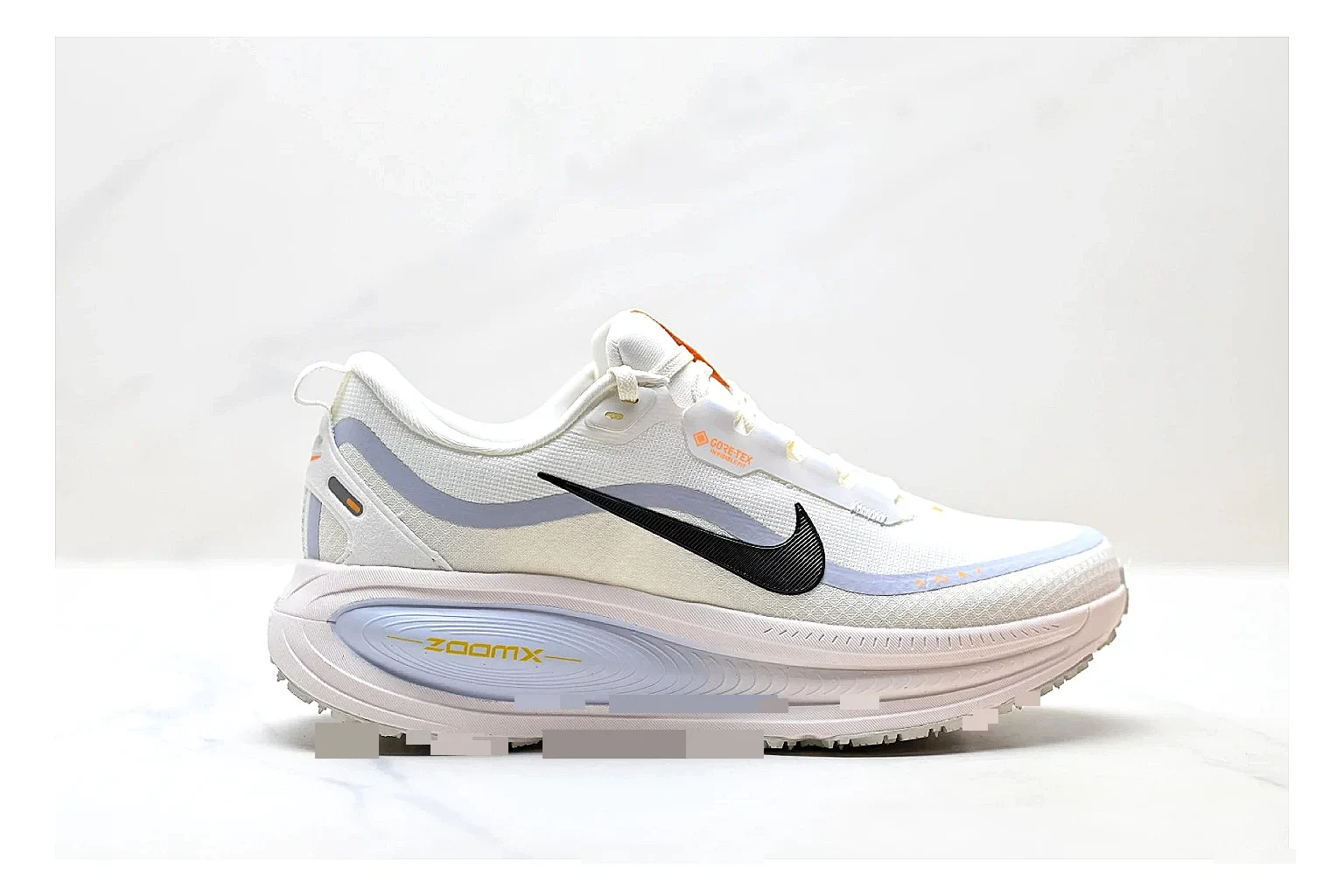 Nike Vomero White Orange QC reference photo showing white mesh runner upper, orange accents, layered Vomero-style panels, and cushioned modern sole