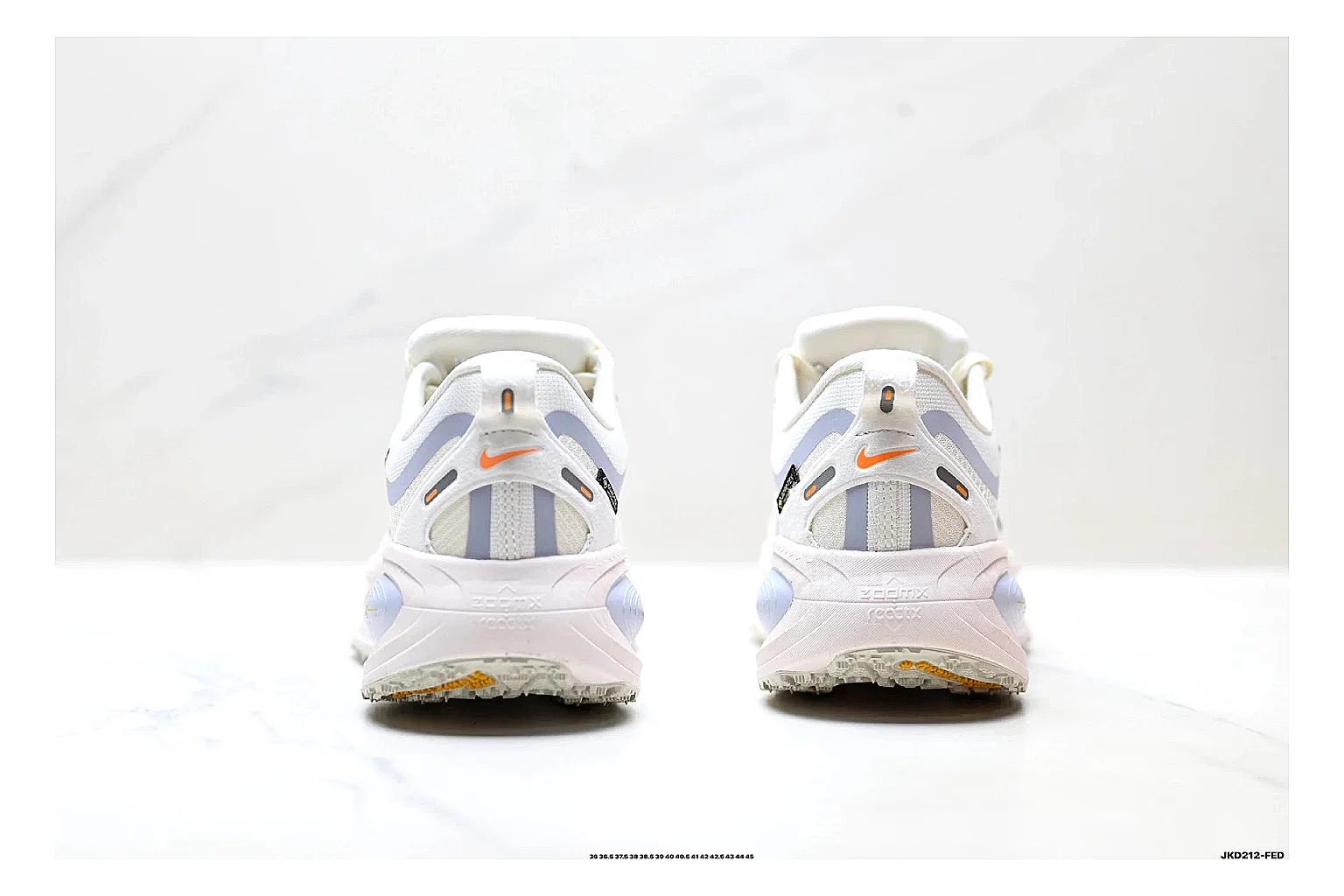 Nike Vomero White Orange QC reference photo showing white mesh runner upper, orange accents, layered Vomero-style panels, and cushioned modern sole