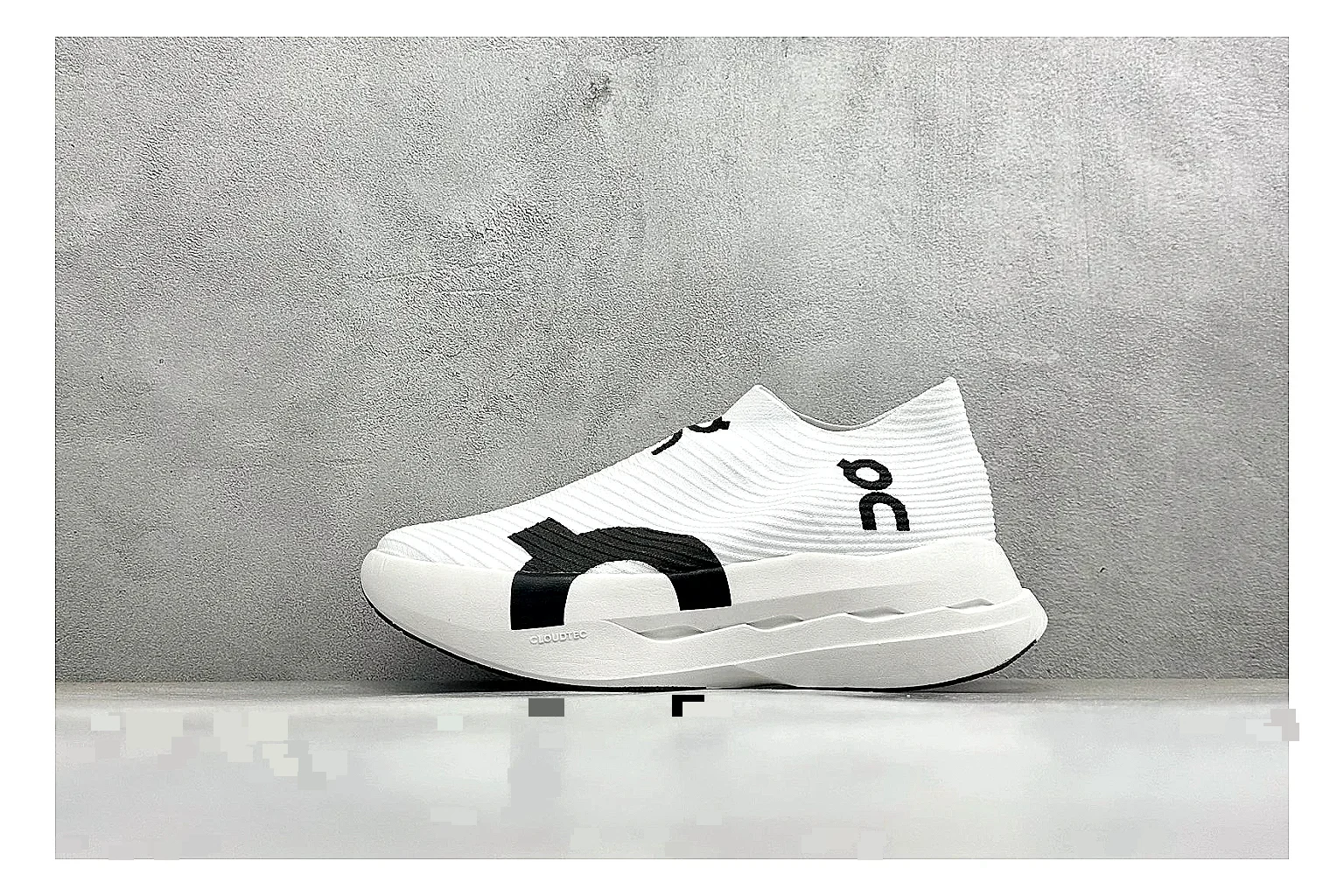 On Cloudboom White Black QC reference photo showing white performance mesh, black contrast details, slim racing profile, and segmented CloudTec sole