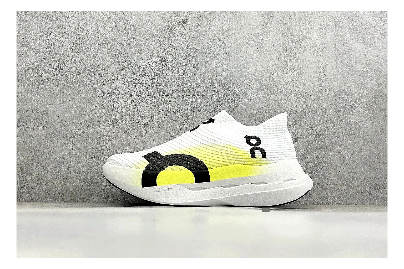 On Cloudboom White Lime QC reference photo showing white performance mesh, lime gradient accents, slim racing profile, and segmented CloudTec sole