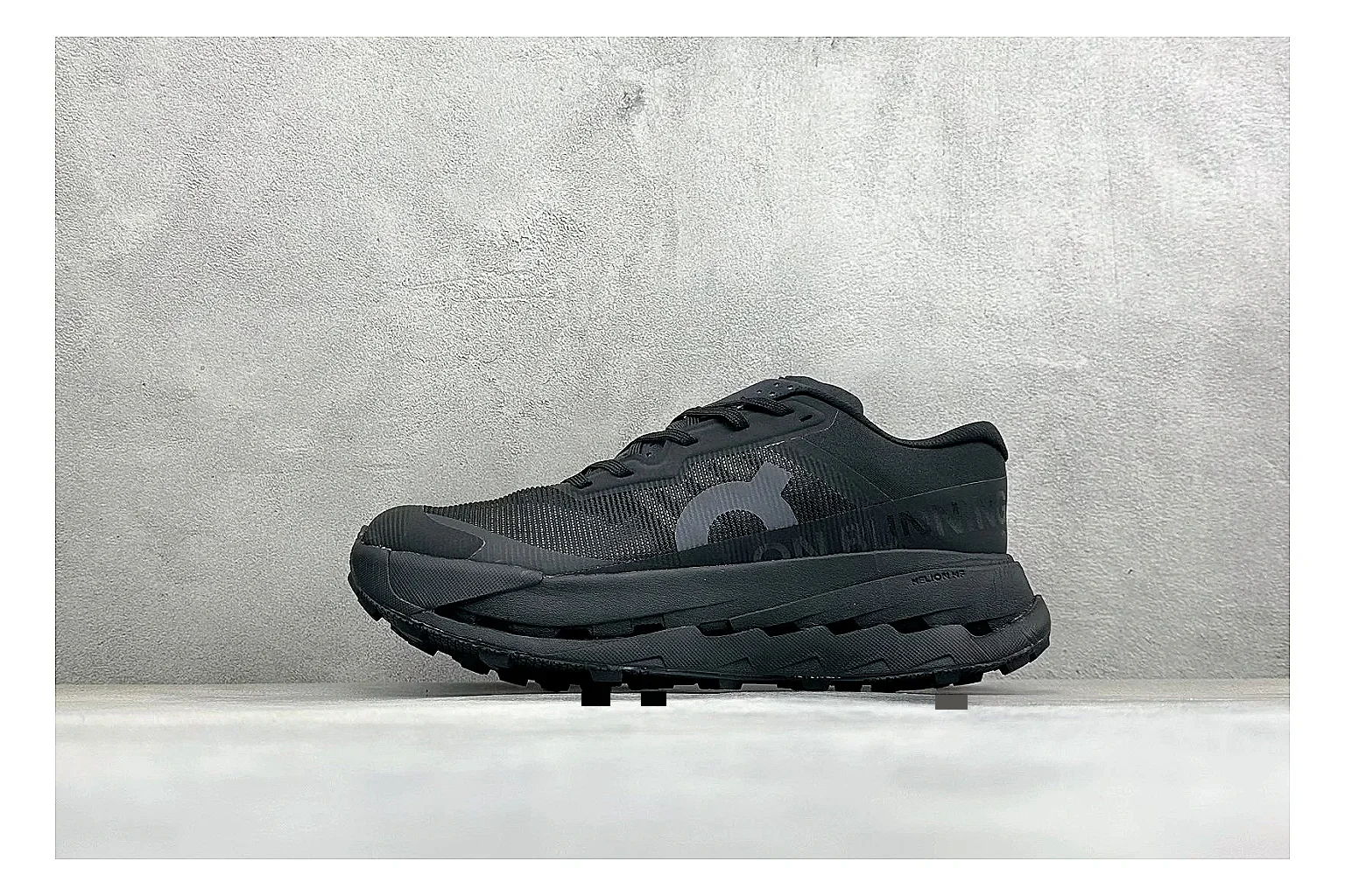 On Cloudmonster Triple Black QC reference photo showing triple black mesh upper, oversized CloudTec sole pods, tonal laces, and rounded runner shape