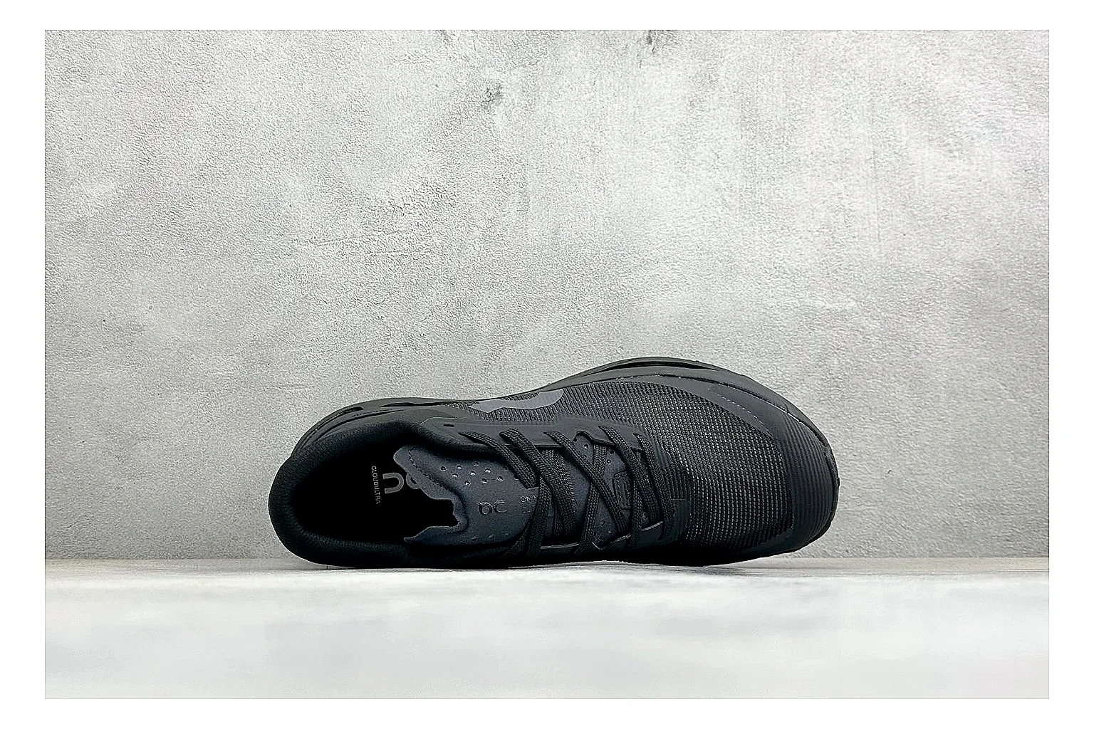 On Cloudmonster Triple Black QC reference photo showing triple black mesh upper, oversized CloudTec sole pods, tonal laces, and rounded runner shape thumbnail 6