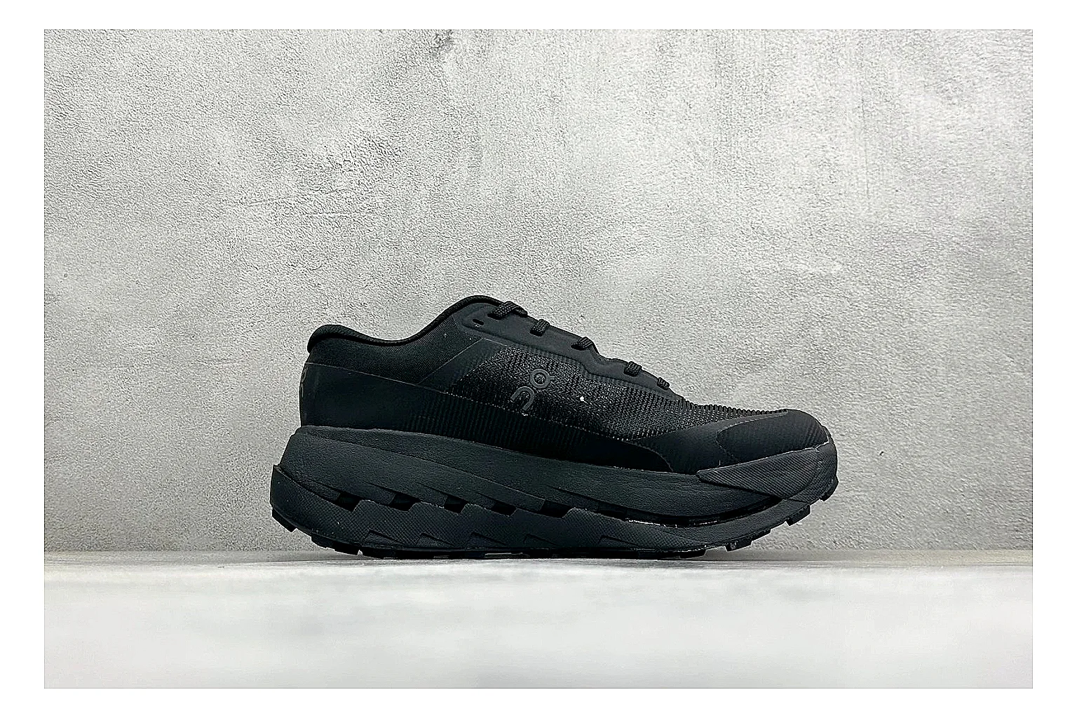 On Cloudmonster Triple Black QC reference photo showing triple black running upper, oversized CloudTec pod sole, tonal laces, and rounded performance shape thumbnail 5