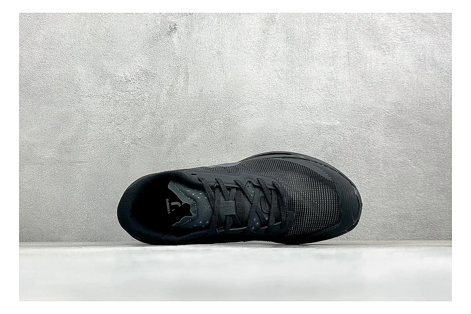 On Cloudmonster Triple Black QC reference photo showing triple black running upper, oversized CloudTec pod sole, tonal laces, and rounded performance shape thumbnail 6