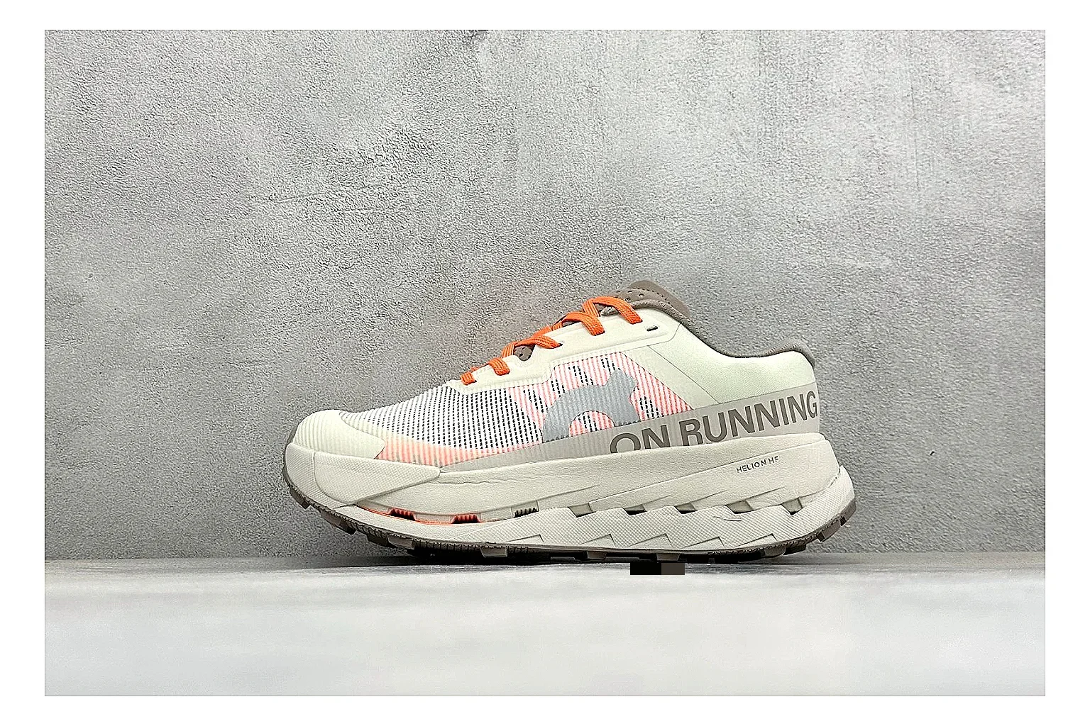 On Cloudmonster White Orange QC reference photo showing white running mesh, orange accent hits, oversized CloudTec sole pods, and a rounded runner silhouette