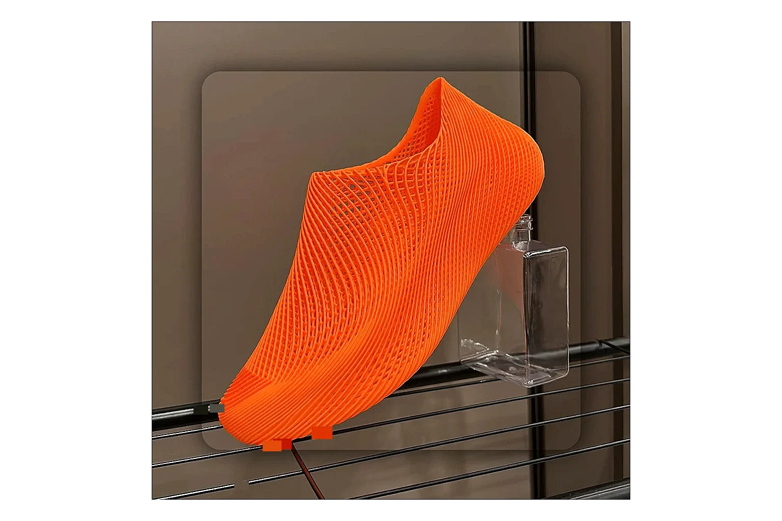 Other 4D Printed Orange Slip-On Sneakers QC reference photo showing orange open-grid upper, seamless slip-on shape, sculpted sole, and futuristic lightweight profile