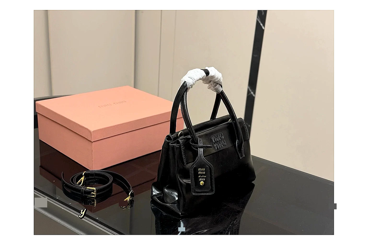 Prada Mini Top Handle Black QC reference photo showing black leather mini bag body, structured top handle, compact luxury shape, and clean hardware details