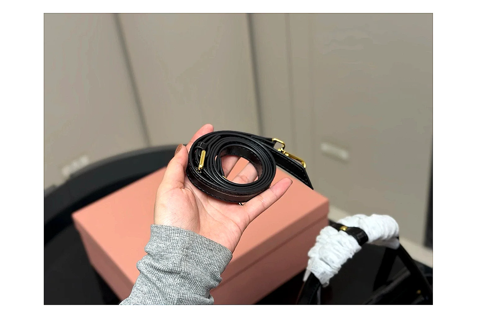 Prada Mini Top Handle Black QC reference photo showing black leather mini bag body, structured top handle, compact luxury shape, and clean hardware details