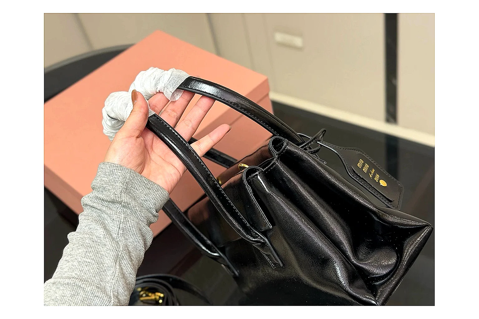 Prada Mini Top Handle Black QC reference photo showing black leather mini bag body, structured top handle, compact luxury shape, and clean hardware details thumbnail 4