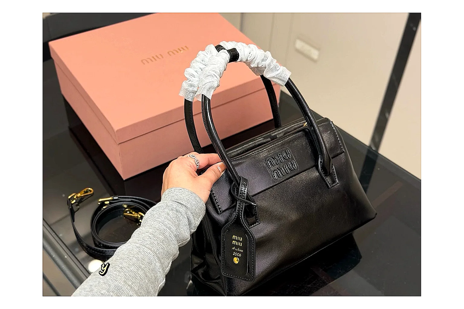 Prada Mini Top Handle Black QC reference photo showing black leather mini bag body, structured top handle, compact luxury shape, and clean hardware details thumbnail 5