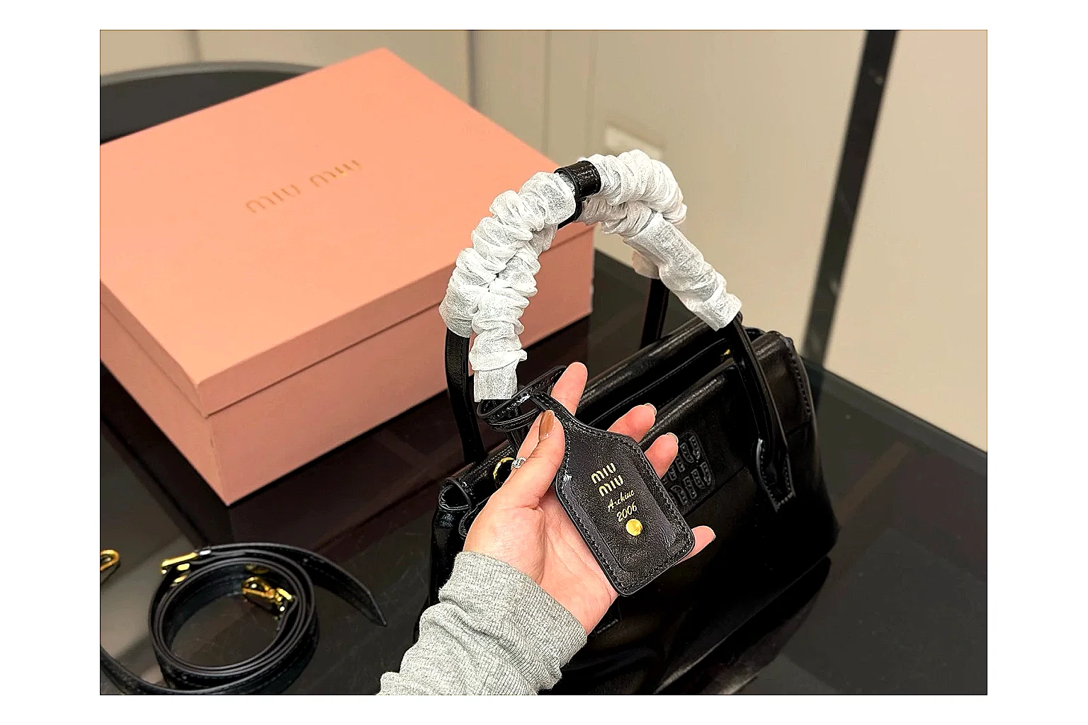 Prada Mini Top Handle Black QC reference photo showing black leather mini bag body, structured top handle, compact luxury shape, and clean hardware details thumbnail 6