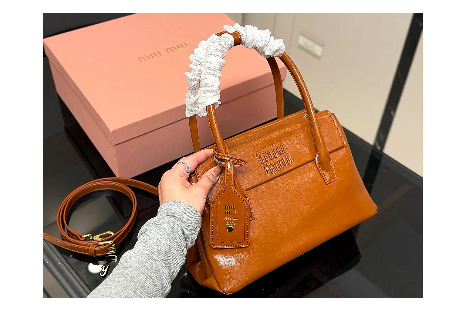 Prada Mini Top Handle Orange Brown QC reference photo showing orange brown leather mini bag body, structured top handle, compact shape, and clean hardware details thumbnail 5