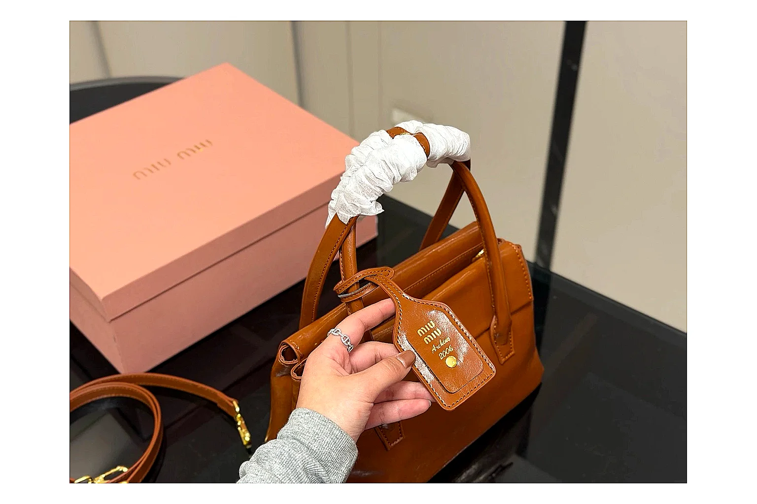 Prada Mini Top Handle Orange Brown QC reference photo showing orange brown leather mini bag body, structured top handle, compact shape, and clean hardware details thumbnail 6