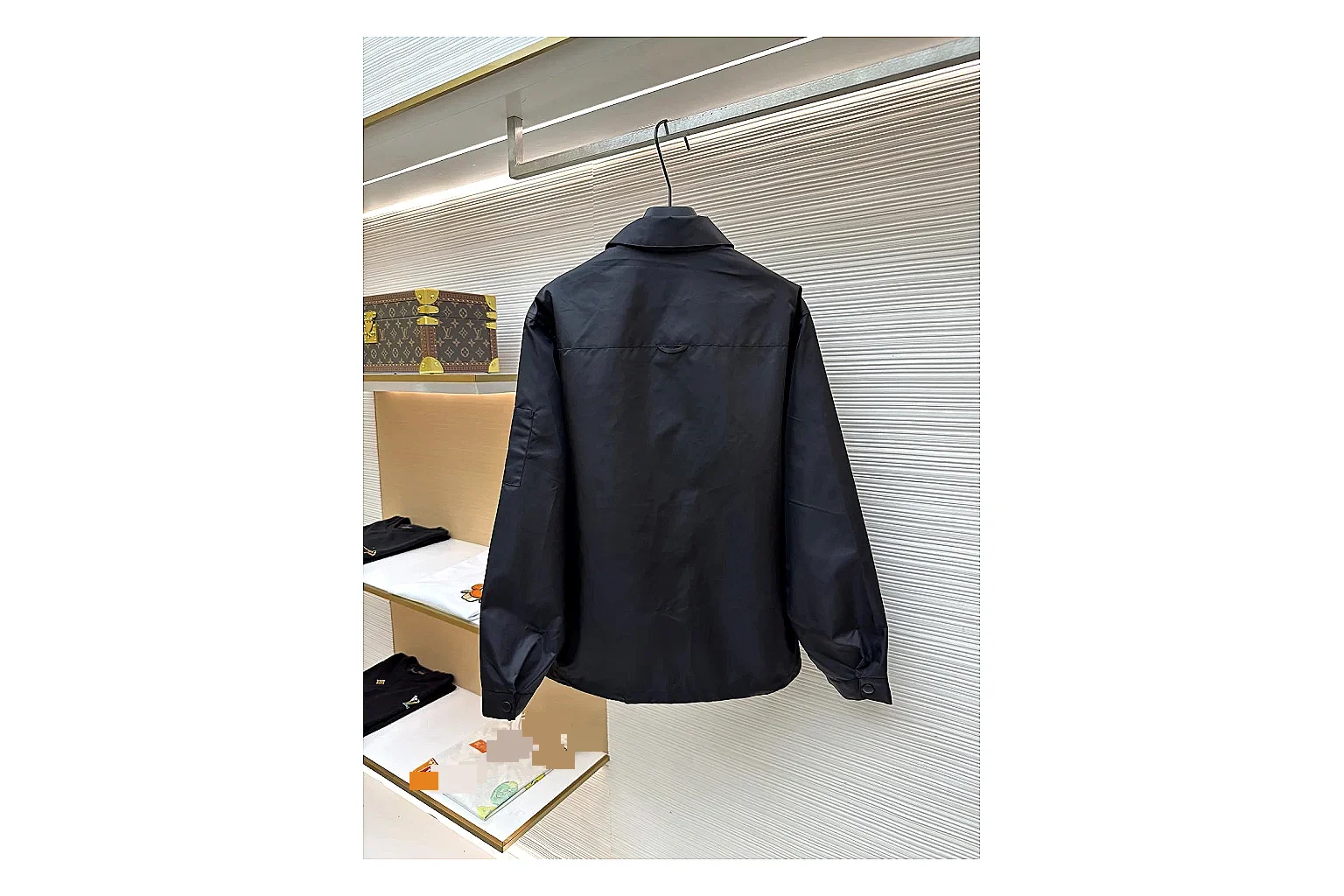 Prada Re-Nylon Hooded Jacket Black Jacket QC photo reference showing black Re-Nylon hooded jacket with recycled-nylon texture, hood structure, zipper line, sleeve cuffs, and light shell shape
