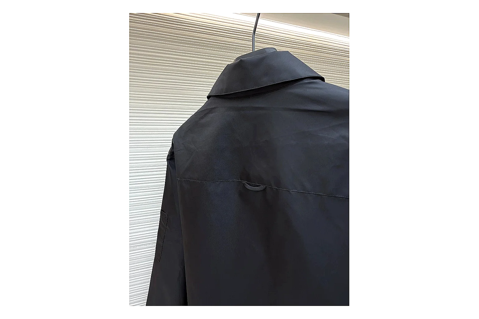 Prada Re-Nylon Hooded Jacket Black Jacket QC photo reference showing black Re-Nylon hooded jacket with recycled-nylon texture, hood structure, zipper line, sleeve cuffs, and light shell shape thumbnail 3